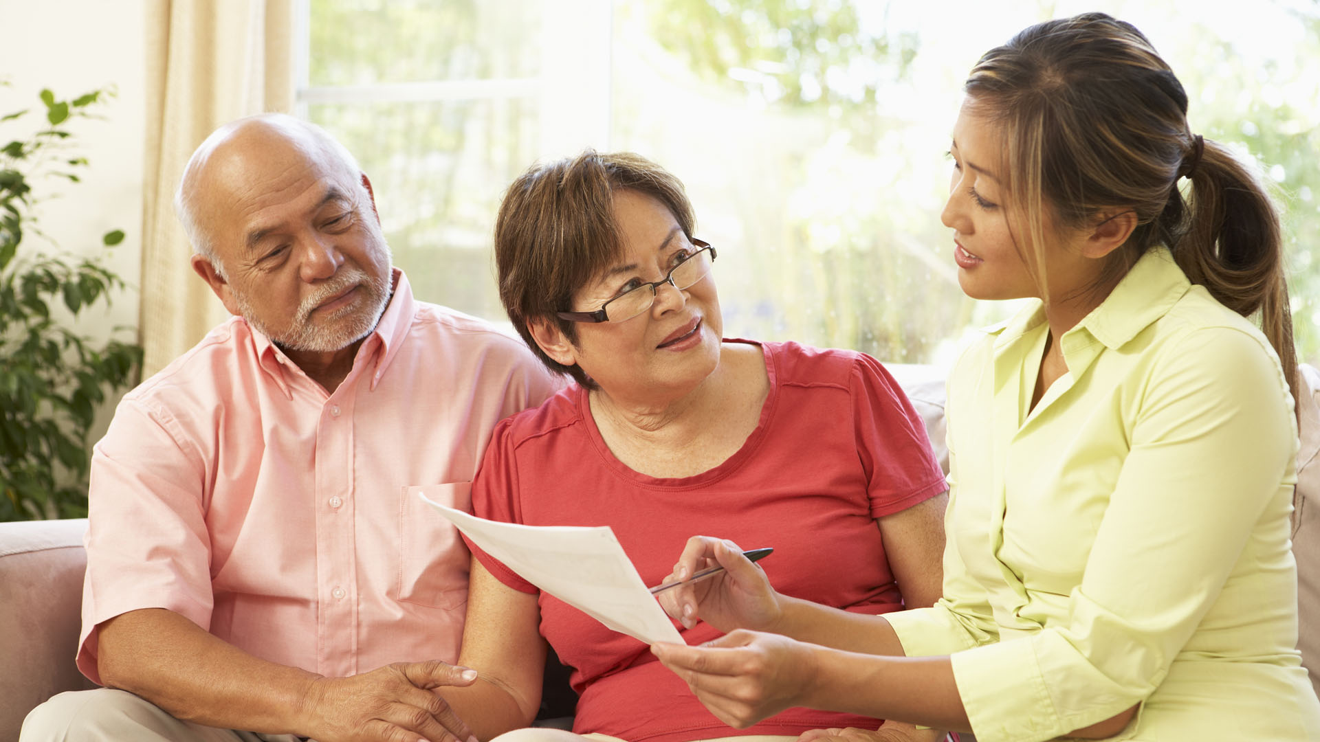 Senior Couple Talking To Financial Advisor At Home